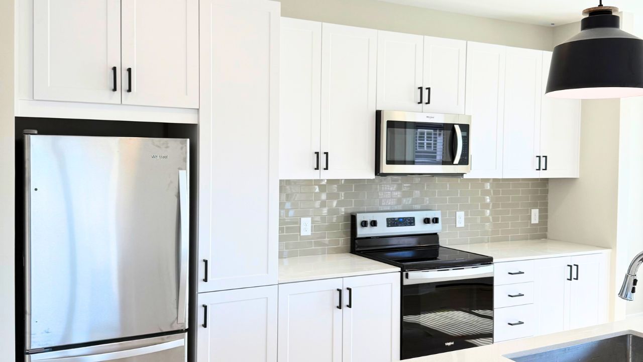 Commercial kitchen installation with white cabinets